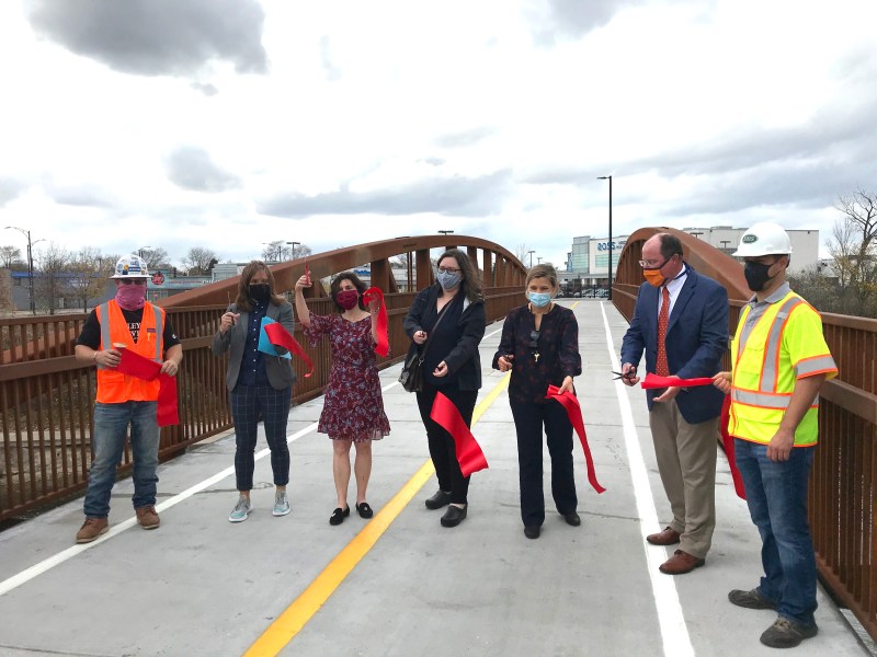 Participants, including CDOT chief Gia Biagi (2nd from left), Alderman Debra Silverstein (3rd from left), and ATA's Julia Gerasimeko (4th from left), cut the ribbon on the new bridge. Photo: John Greenfield