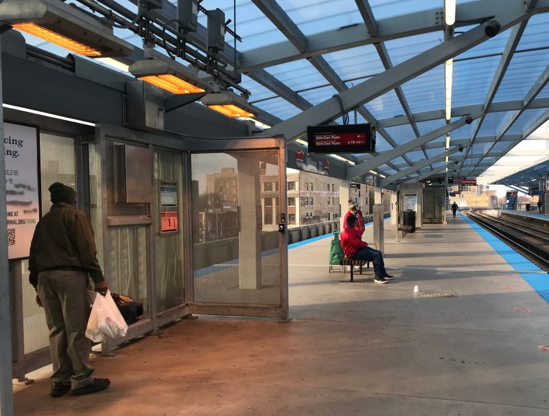 Waiting beneath overhead heaters on the Wilson platform. Photo: John Greenfield