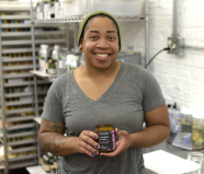 Soap Distillery owner Danielle Martin with one of her lavender paloma-scented candles.