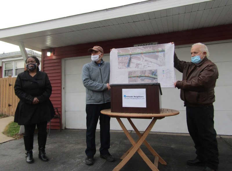 Hillside Neighbors press conference in November at Roger Romanelli's (center) home, with mayoral candidate Gwen Amber and trustee candidate Dan Adams. Note that, unlike what Romanelli and Adams are demonstrating here, face masks should be worn over both the nose and mouth. Photo: Igor Studenkov