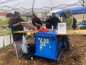 William Estrada and his art cart engaging "Moving Freely" visitors