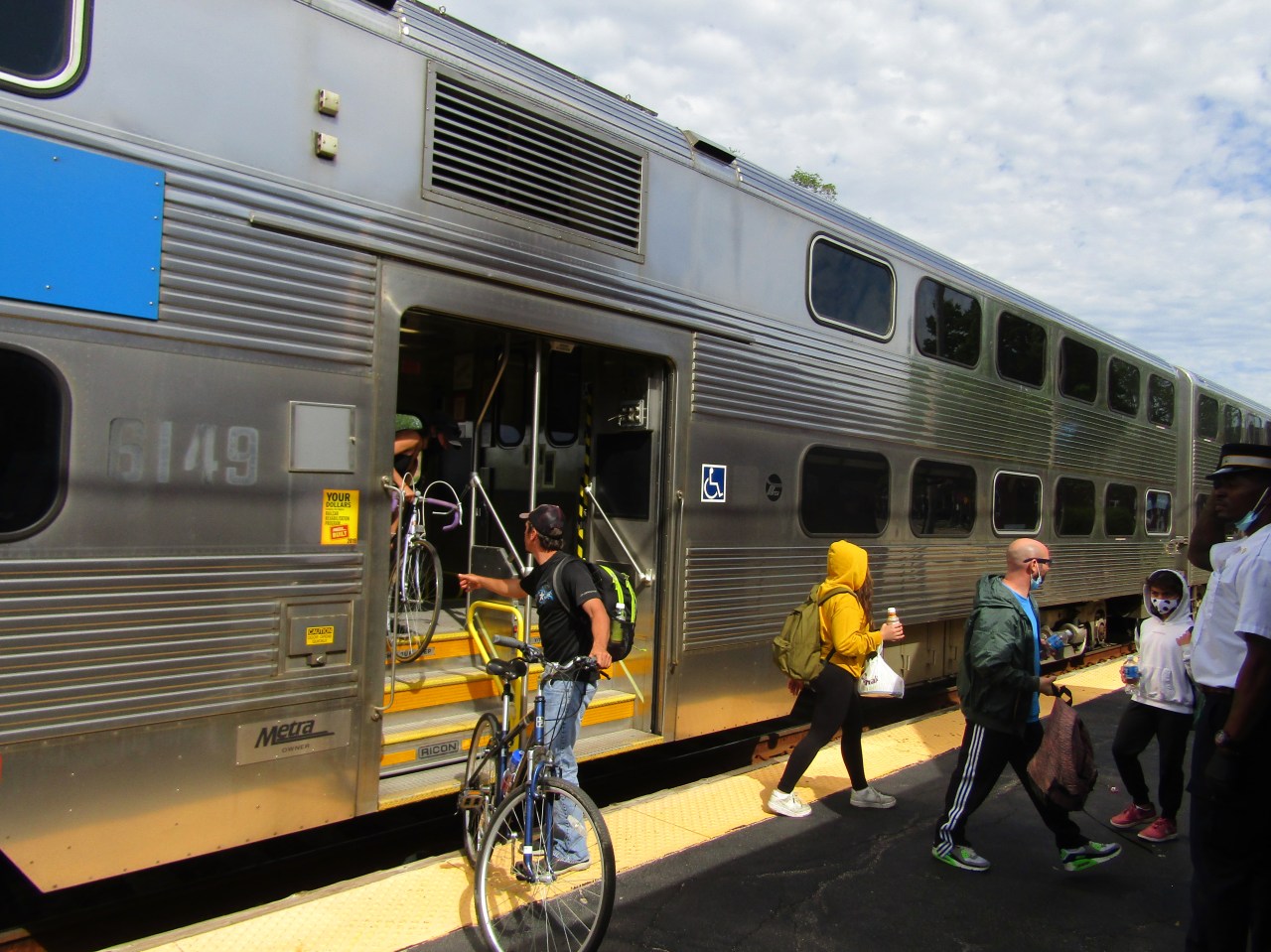 Cyclists disembark at at the UP-Northwest line's Woodstock station.