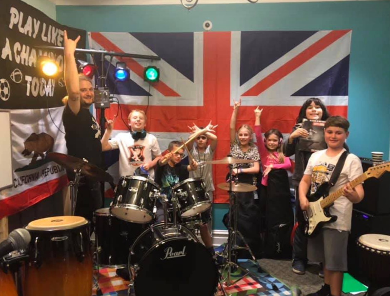 Kevin Clark with young musicians. Photo via Kevin's Coda