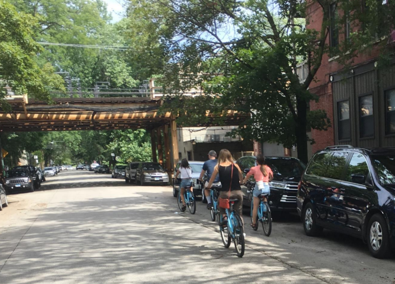 Eastbound cycling is already common on Dickens, a one-way westbound street. The contraflow bike lane will make it safe and legal. Photo: CDOT