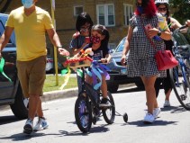 A child heads north on Drake St. during the parade as part of the blessing of the bikes of Tabor Lutheran Church. Photo: Imelda March