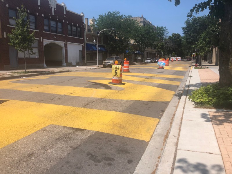 Paulina St looking northbound. Traffic barrels outline a path for drivers. Signs on the barrels either read "Slow Down: 5 MPH" or "Slow Down: Shared Street: Yield to Pedestrians"
Photo: Courtney Cobbs