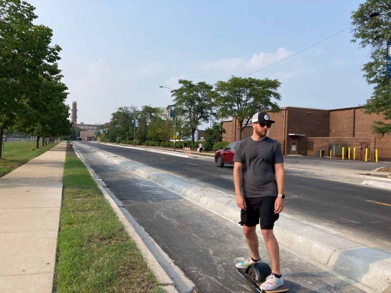 A hoverboard user test-rides the new concrete-protected bike lanes on Campbell. Photo: John Greenfield