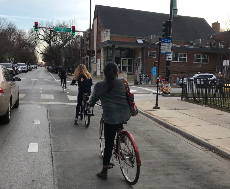 Cyclists riding in dashed bike lanes on Damen Avenue in Lakeview near Liza Whitacre’s "ghost bike" memorial. Photo: John Greenfield