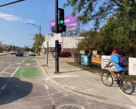 Some people biking on Clark are using the sidewalk rather than take their chances in the half-finished, car-clogged bike lanes. Photo: John Greenfield