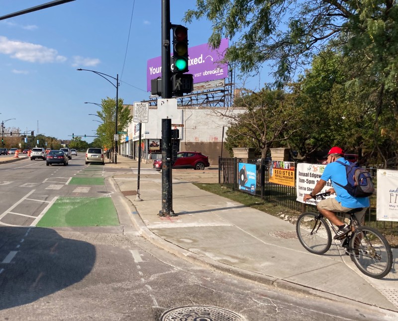 Some people biking on Clark are using the sidewalk rather than take their chances in the half-finished, car-clogged bike lanes. Photo: John Greenfield
