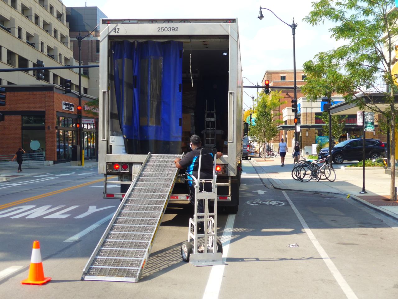 A SYSCO food service driver parks in the travel lane instead of the bike lane, with flashers and cones. Photo: Twitter user @Billeeejo