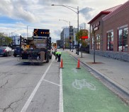 A worker bolts down a bollard on Clark Street. Photo: John Greenfield
