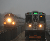 A Metra Union Pacific West train and a CTA Green Line train cross paths on Lake Street. Photo: Jeff Zoline