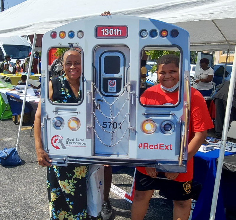 Photo opp at an info table on the Red Line extension at a South Side community festival last summer. Photo: CTA