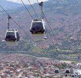 Medellín Metrocable cars. Researchers found a correlation between infrastructure investments in the station neighborhoods and lower homicide rates and increased societal trust. Photo: Camilo Sanchez via Wikipedia