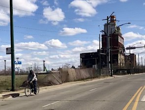 A person biking past the Crawford power plant site in April 2020. Photo: Mia Park