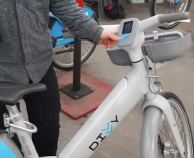 Unlocking the new gray Divvy e-bikes with a key fob by placing the fob under the LCD screen. Photo: Divvy
