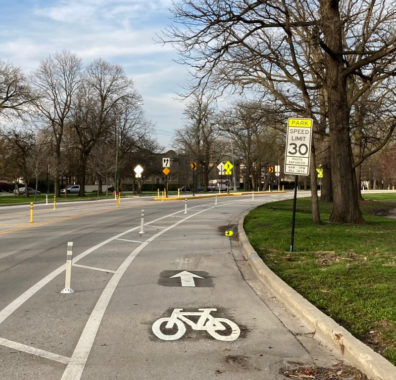Warning sign for automated speed enforcement, along with new bike lanes and pedestrian islands, on Jackson Boulevard in Austin's Columbus Park. Photo: John Greenfield