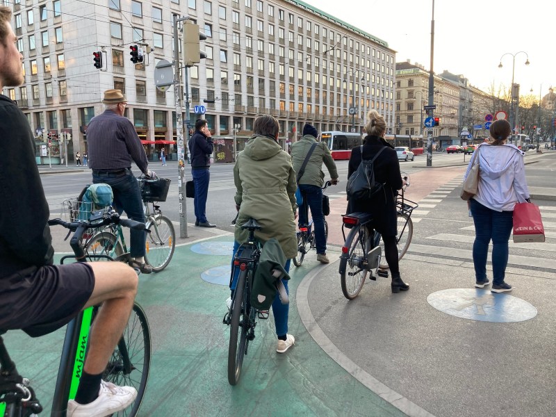 Waiting for a light on a sidewalk-level bike lane in Vienna, which appears to have a seamless network of car-separated bikeways. Photo: John Greenfield