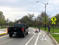The driver of a monster pickup truck stops for a family using one of the new pedestrian islands in Columbus Park. Photo: John Greenfield