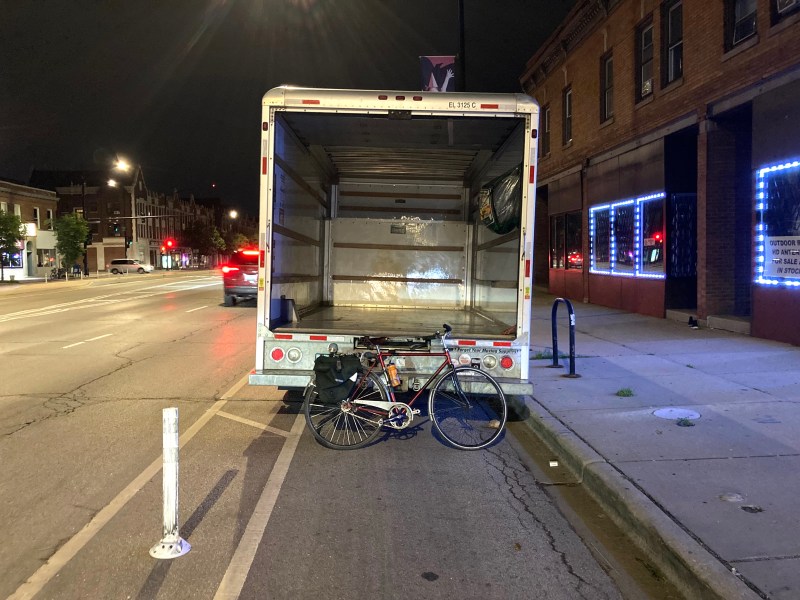 A moving truck parked in one of the flexi-post bike lanes on Clark Street in Edgewater. Concrete protection can help prevent illegal parking in bikeways. Photo: John Greenfield