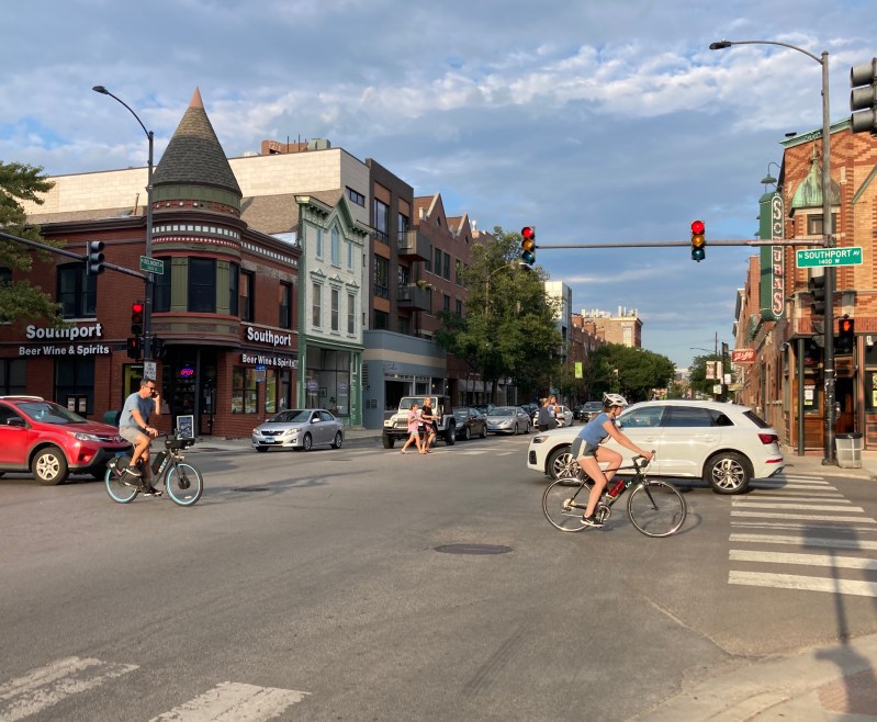 Looking east on Belmont Avenue at Southport Avenue, which has non-protected bike lanes. (Yes, we know talking on the phone while biking is illegal in Chicago and is not recommended.) Photo: John Greenfield