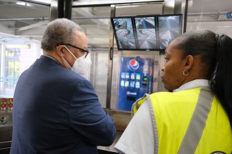 Carter and a customer assistant with one of the new security camera monitors. Photo: CTA