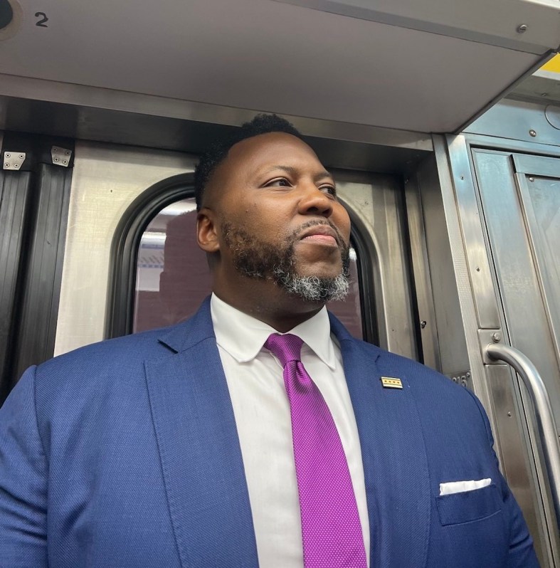 Buckner rides the Red Line. Photo courtesy of the Kam Buckner campaign.